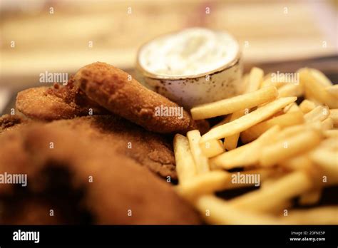 Fish and chips with sauce in restaurant Stock Photo - Alamy