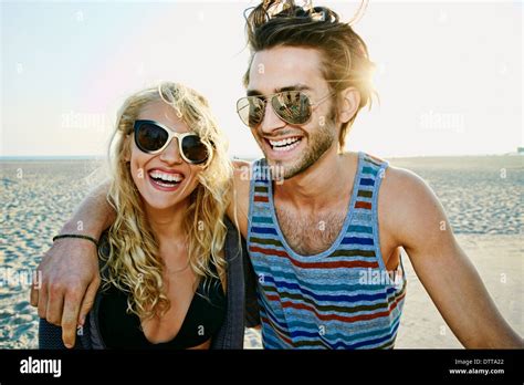 Couple smiling together on beach Stock Photo - Alamy