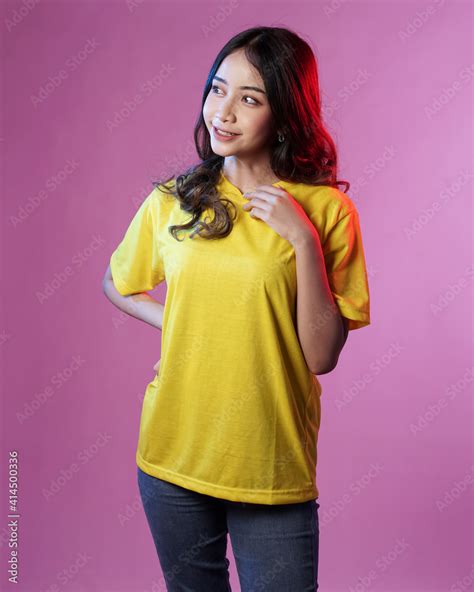 Young female model wearing blank T-shirt in studio background. Woman in ...