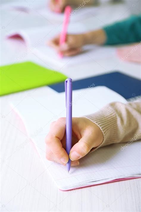 Hands of students at school Stock Photo by ©belchonock 73481589