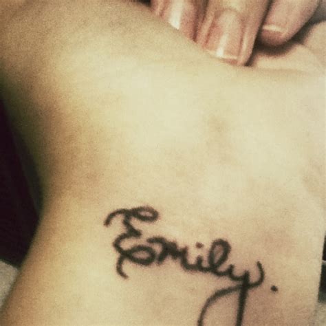 "Emily" tattoo on wrist