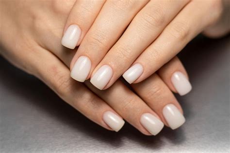Premium Photo | Beautiful nude manicure. short square nails. nail design. manicure with gel ...