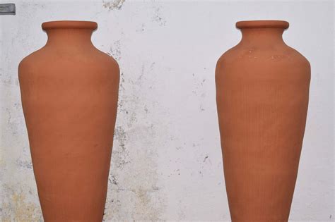two brown vases sitting next to each other