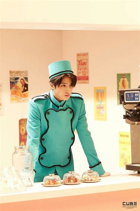 a man in a blue suit and top hat behind a counter
