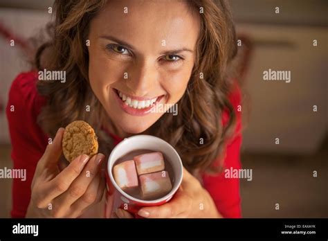 Young woman eating chocolate biscuits hi-res stock photography and ...