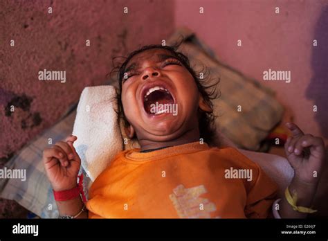 A crying young child baby at home in a slum in Mumbai, India Stock Photo - Alamy