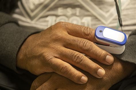 Fingertip oxygen sensors can fail on dark skin — now a physician is suing