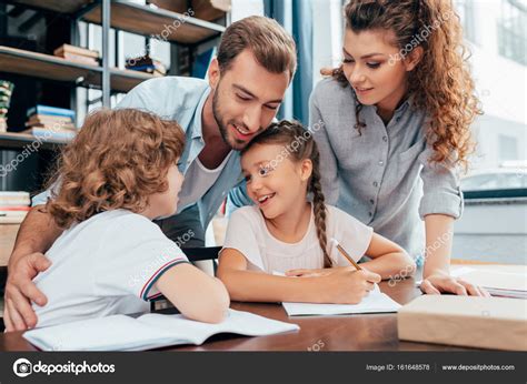 Parents doing homework with kids Stock Photo by ©AlexLipa 161648578