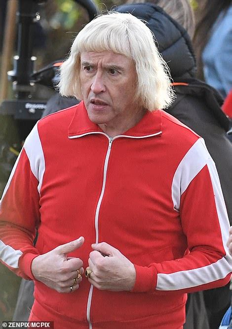 Steve Coogan is unrecognisable as he transforms into Jimmy Savile in his trademark red tracksuit ...