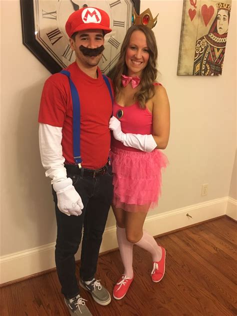 a man and woman are dressed up as mario and princess peach from mario kart