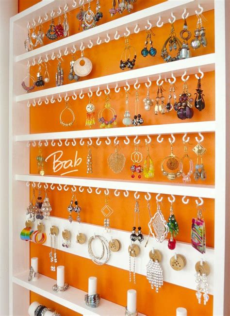 an orange and white wall with jewelry on it's shelves in front of the door