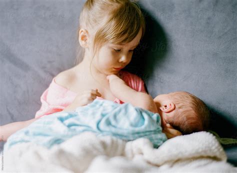 "Little Girl Holding Her Baby Brother" by Stocksy Contributor "Marta ...