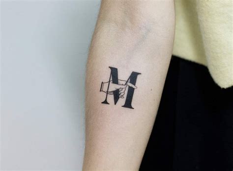 Letter M by tattooist Fury Art - Tattoogrid.net