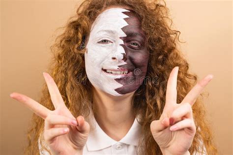 Headshot of Optimistic Fan Football Redhead Woman with Face Painted in Qatar Flag Showing ...