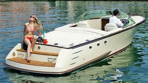 a woman sitting on the back of a white boat