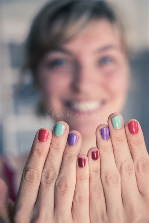 27+ Fakten über Nail Polish Promising Young Woman Nails! Woman applying nail varnish to finger ...