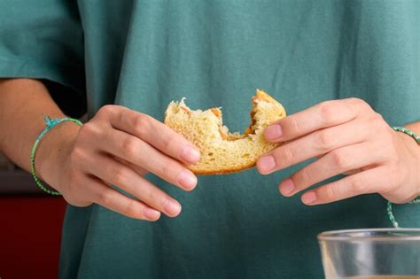 Premium Photo | Female hands holding a bitten peanut butter sandwich with honey of wheat bread ...