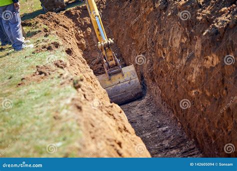 Backhoe - Digging a Trench stock photo. Image of horizontal - 142605094