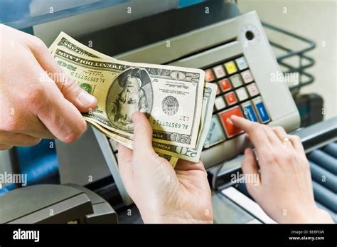 Customer paying to cashier Stock Photo - Alamy