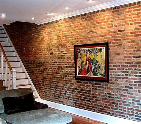 a living room with brick walls and stairs