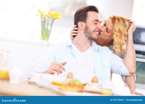 Woman Giving Good Morning Kiss To Her Husband Stock Photo - Image: 52710431