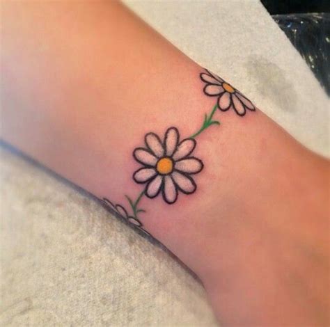 White Daisy Flower Tattoo On Ankle | Daisy chain tattoo, Anklet tattoos, Daisy tattoo