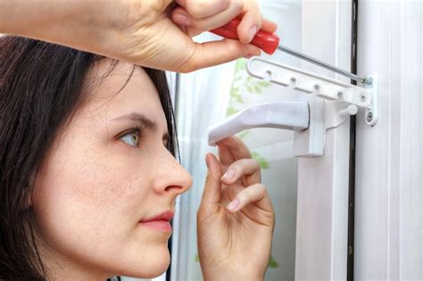 Premium Photo | Woman fixing window handle