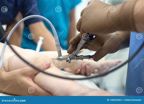 A Team Of Urologist Doctors Performing A Cystoscopy Using A Cystoscope. In A Sterile Operating ...