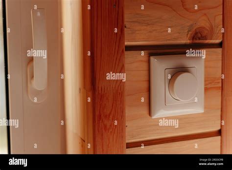 Close up electrical dimmer switch light for adjustable brightness control in wooden house Stock ...