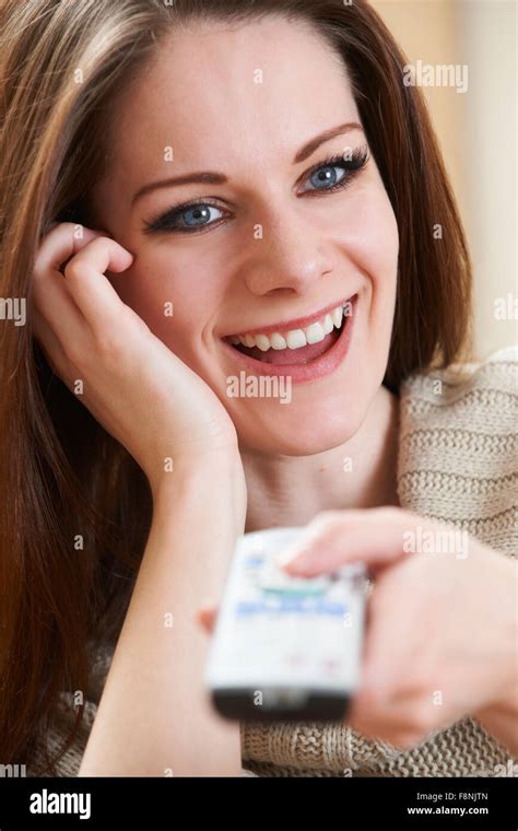 Woman Watching TV Holding Remote Control Stock Photo - Alamy