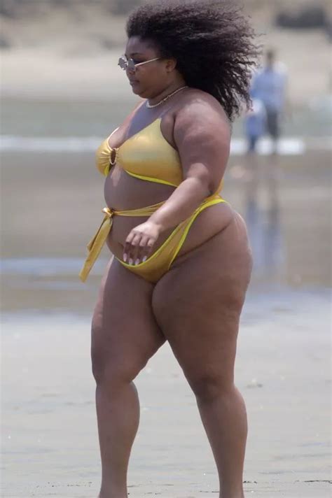 Lizzo storms the beach with confidence in gold cutaway swimsuit in New Zealand - Irish Mirror Online