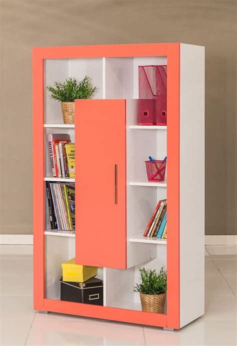 an orange and white bookcase with books on it's shelves next to a ...