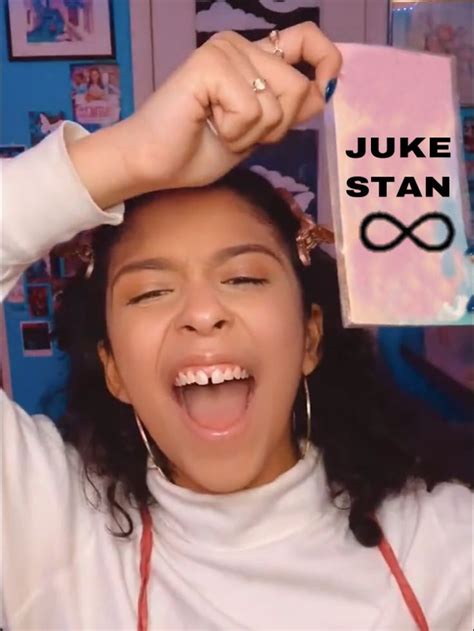 a woman is holding her hair in front of her head with the words juke stan on it