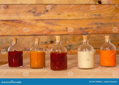 Handmade Spicy Sauces in Glass Bottles with Cork on a Wooden Base Stock Photo - Image of rustic ...