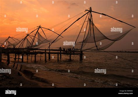 Sunset by the Chinese Fishing nets in Fort Kochi, Kerala India Stock ...