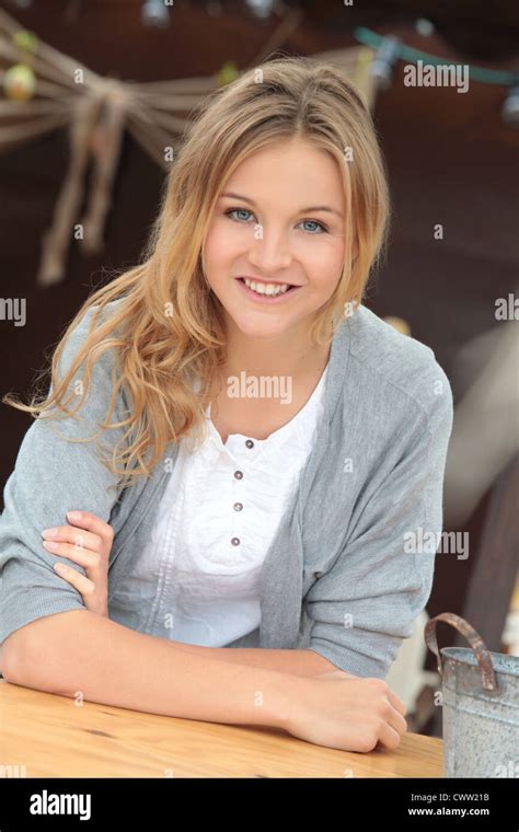 Smiling woman leaning on bar table Stock Photo - Alamy