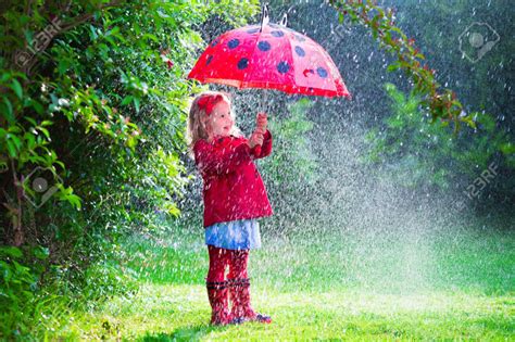 41607821-Little-girl-with-red-umbrella-playing-in-the-rain-Kids-play ...