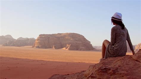 Woman tourist stand on cliff at viewpoint enjoy Wadi rum panorama on ...