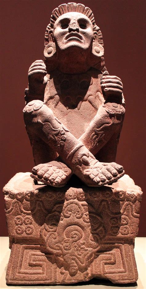 Statue of Xōchipilli (the Aztec God of art, games, dance, flowers, and song) sitting cross ...