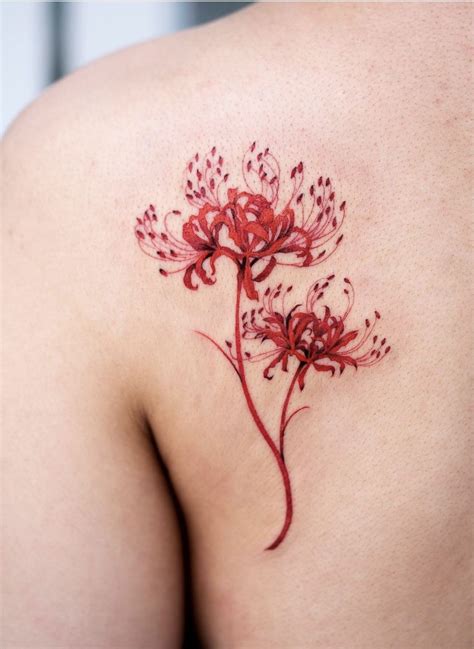 Oozy spider lily flower tattoo | Red ink tattoos, Red tattoos, Creative tattoos