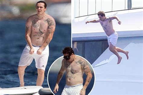 Brooklyn Beckham shows off HUGE tattoo collection as he jumps off a ...