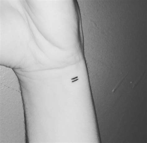 Equal sign tattoo on the left inner wrist.