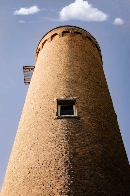 Premium Photo | Round brick tower located in a small municipal park