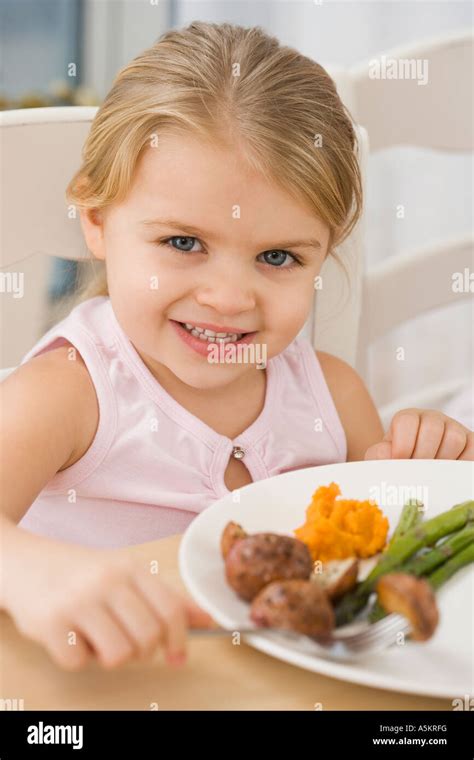 Portrait of girl at dinner table Stock Photo - Alamy