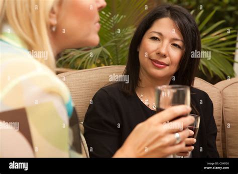 Two Girlfriends Enjoy Wine on the Outdoor Patio Stock Photo - Alamy