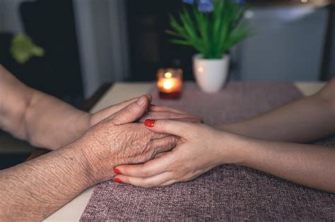 Free Photo | Old and young man holding hands close up