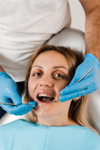 Premium Photo | Cheerful girl smiling at dentists consultation in ...