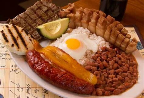 Bandeja Paisa – Colombia’s national dish of rice, beans, chicharron, avocado, arepa, fried egg ...