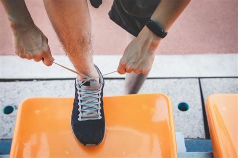 Person tying shoelaces 1226860 Stock Photo at Vecteezy