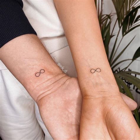 Matching infinity symbol tattoo for couple.